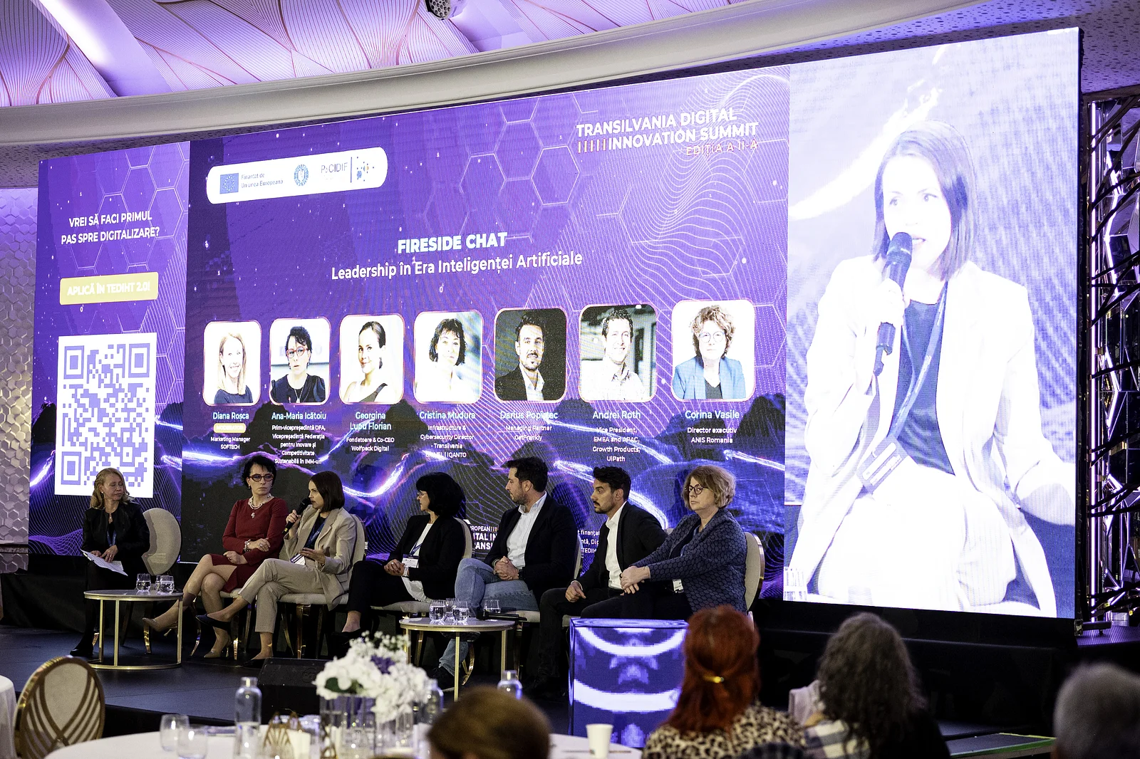 Georgina Lupu Florian speaking on the “Leadership in the AI Era” fireside chat panel at Transilvania Digital Innovation Summit 2026, with the speaker line-up on screen behind her.
