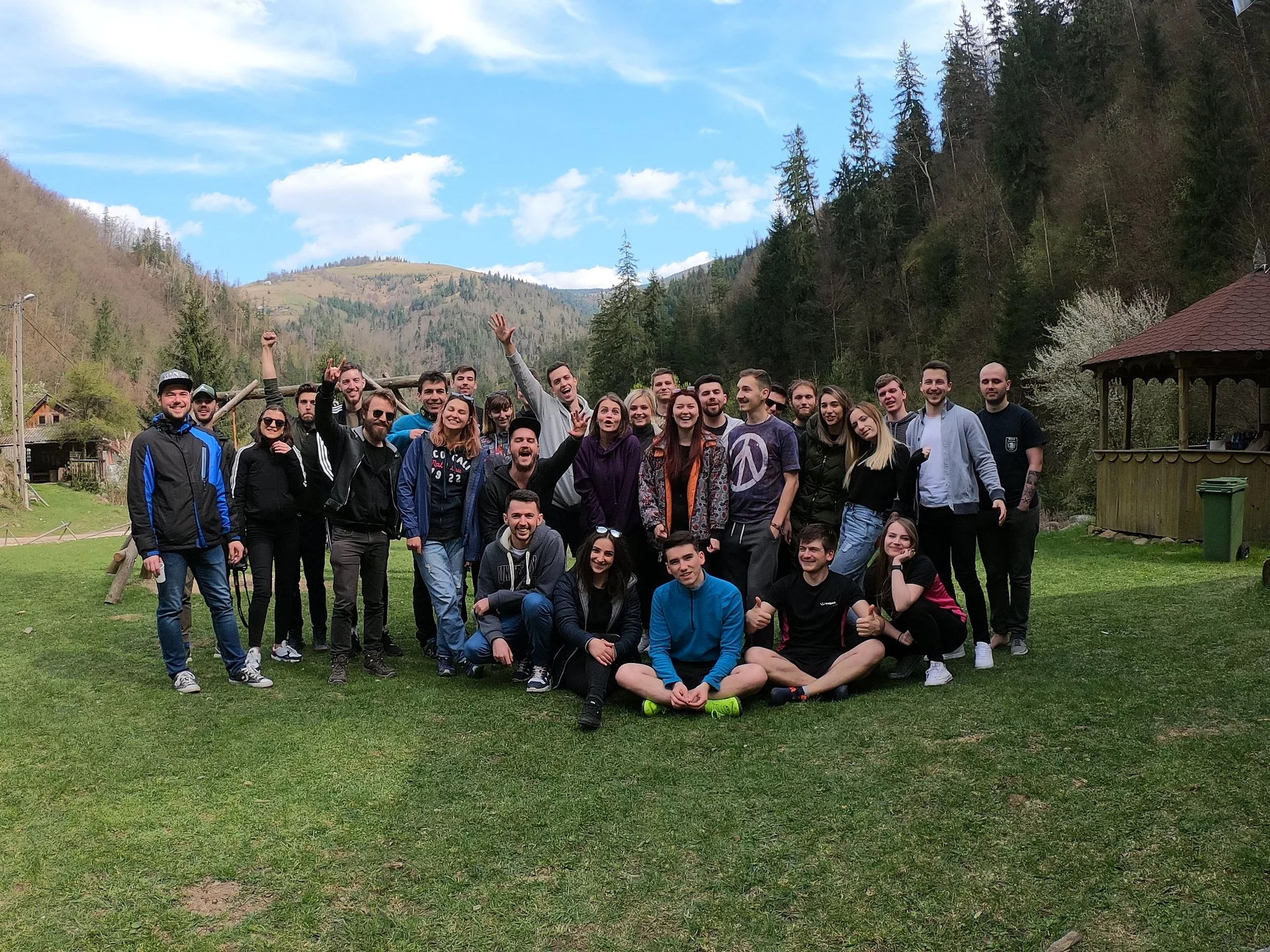 The full Wolfpack Digital team posing outdoors in a green mountain setting